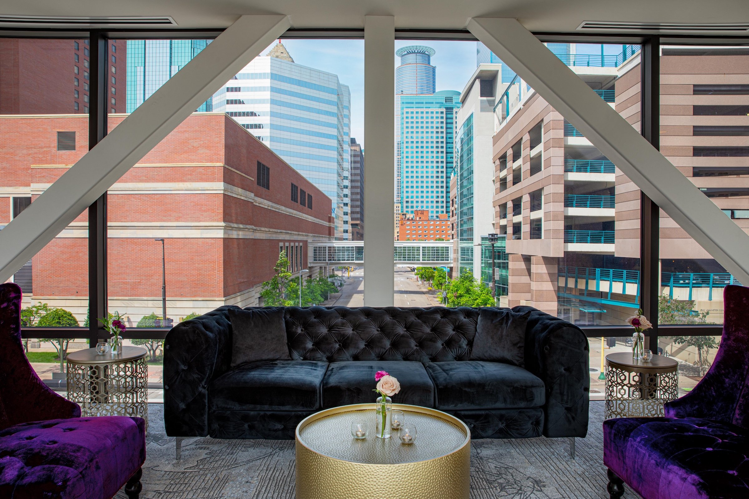 Velvet couches and tea tables with rose from Skyway venue at Hotel Ivy