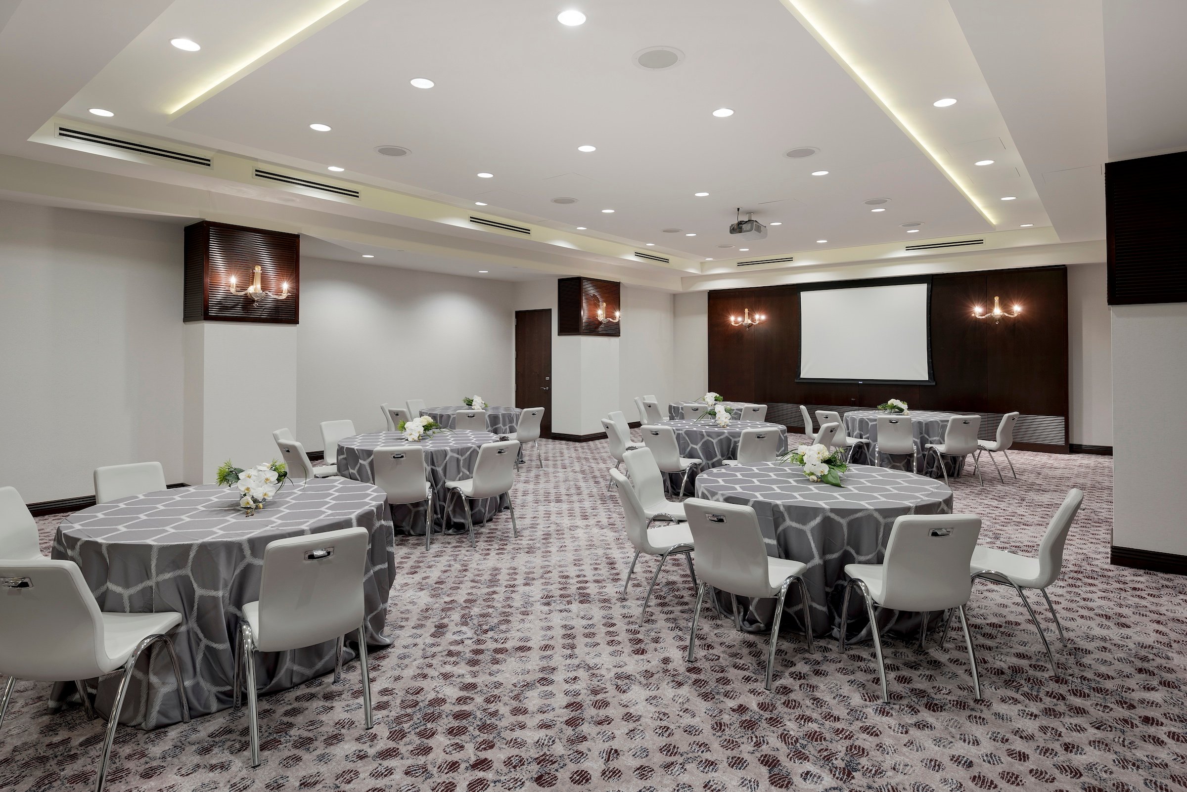 Round tables with grey cloth and chairs in a modern stylish meeting space, Grand Salon of Hotel Ivy