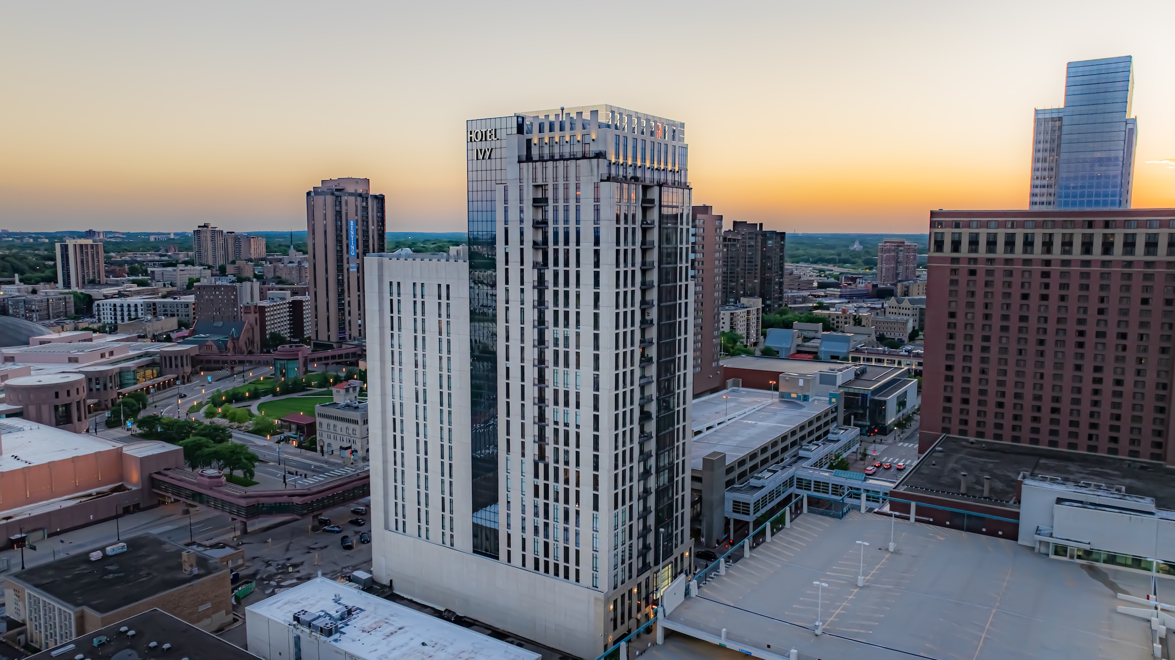 A white tall building with glass of Hotel Ivy with city view